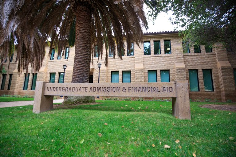 A building with a sign that reads "Undergraduate Admission & Financial Aid" in front.