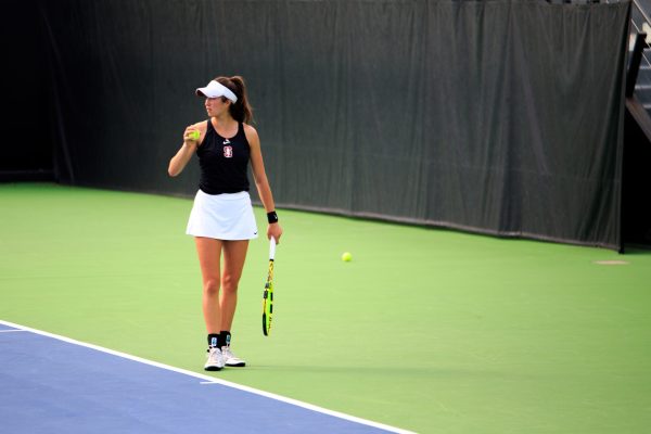 India Houghton stares across the net as she prepares for a serve.