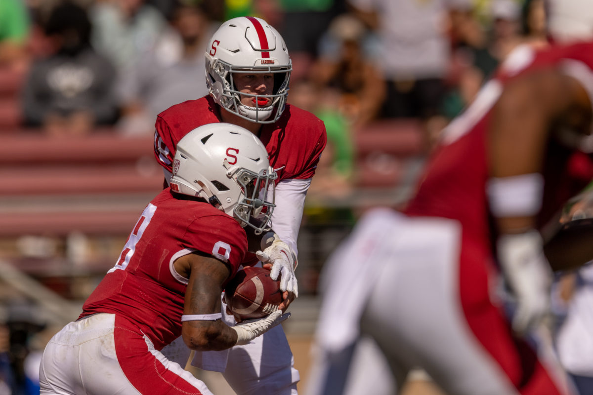 A side shot of junior running back Nathaniel Peat grabbing the ball from Sophomore quarterback Tanner McKee.