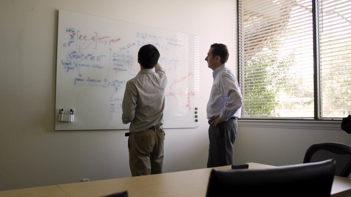 Photo of Etkin working with a student.