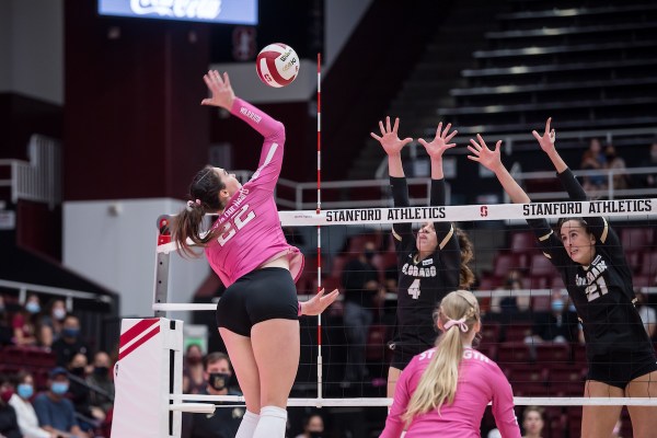 Redshirt sophomore outside hitter Caitie Baird swings above the net.