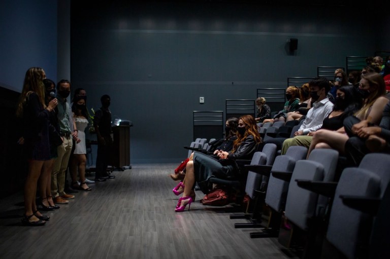 The members of Golden Spike Studio stand in the front as they introduce their film to the audience.