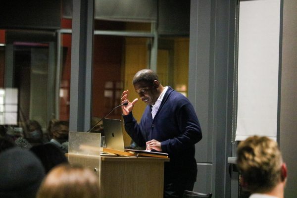 A photo of A. Van Jordan reading at a podium