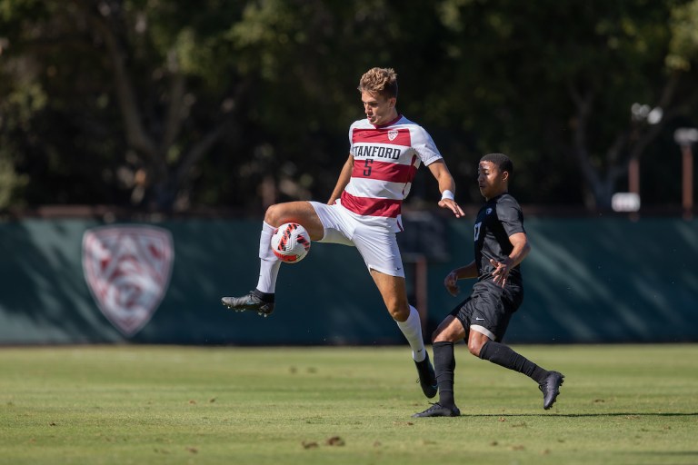 Keegan Hughes controls a pass away from a defender.