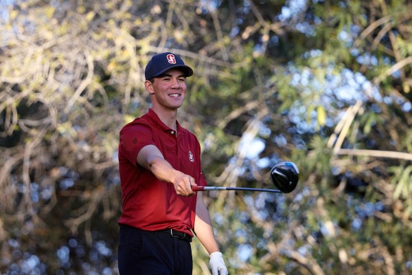 Sophomore Michael Thorbjornsen points his driver following his tee shot.