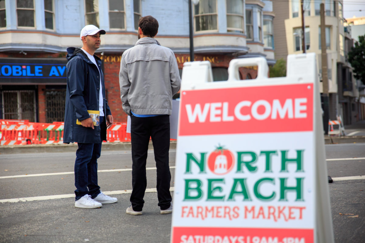 Mahmood speaks to campaign volunteer on the street