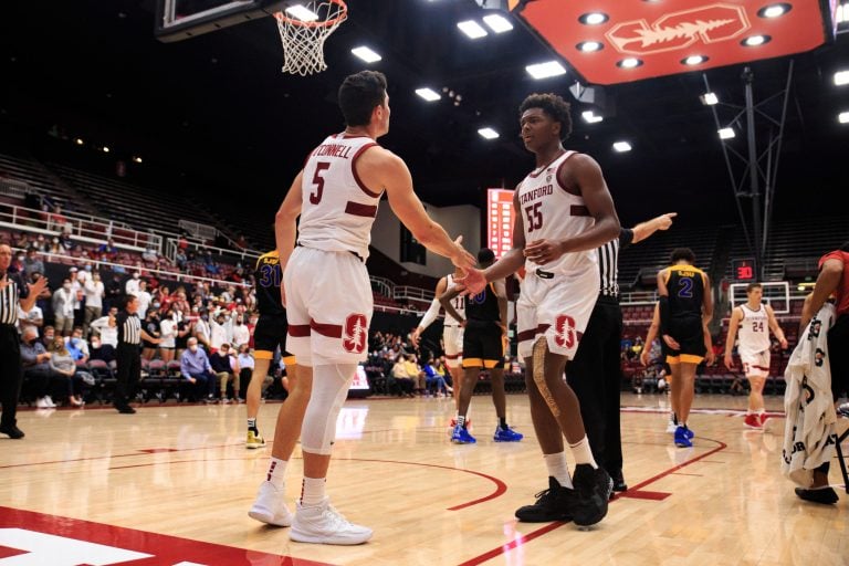 Sophomore guard Michael O'Connell high fives freshman forward Harrison Ingram after a basket.