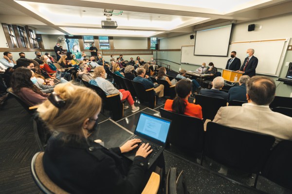 Faculty senators at a lecture hall