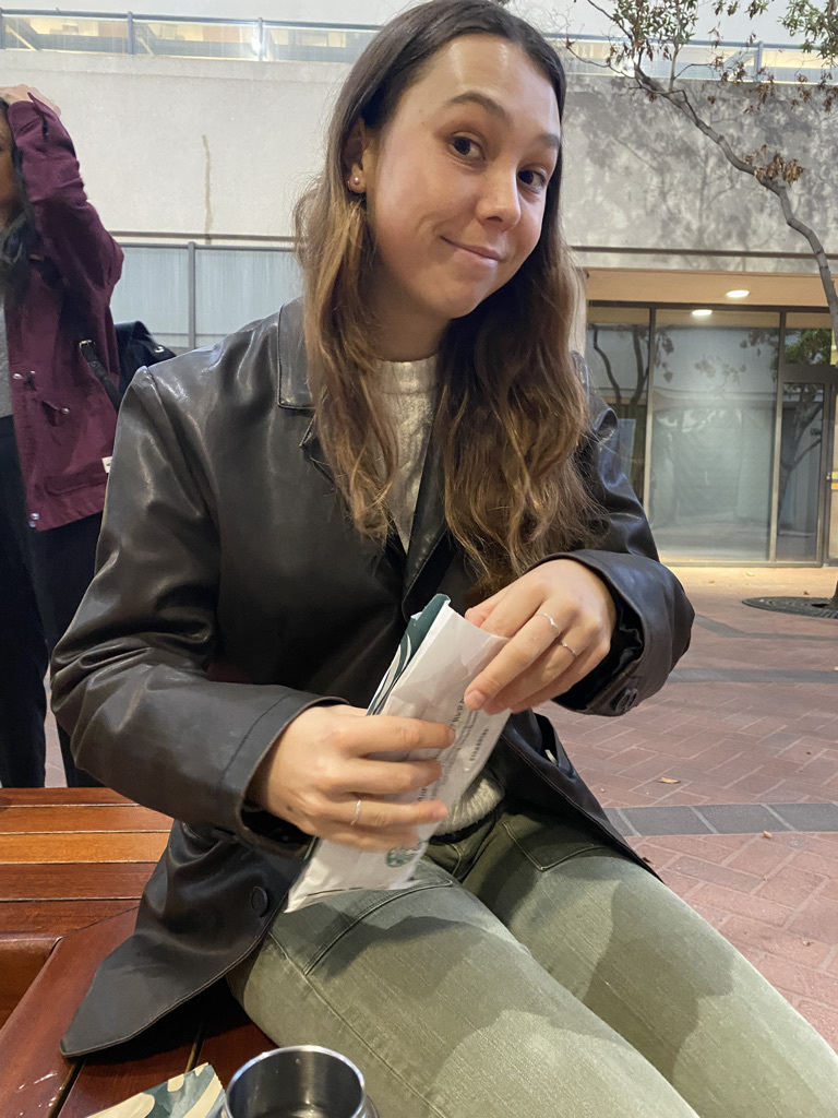 Piper with Starbucks breakfast before court, and a lawyer entering the courthouse with files.