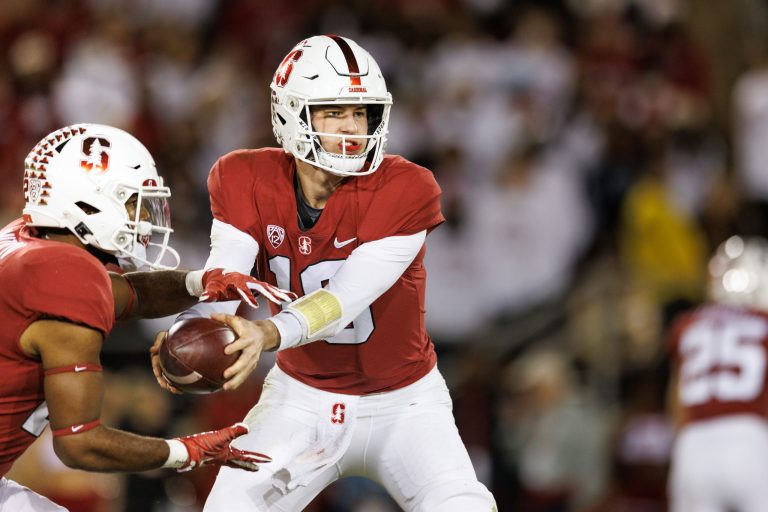 Tanner McKee hands the ball off to a Cardinal running back.