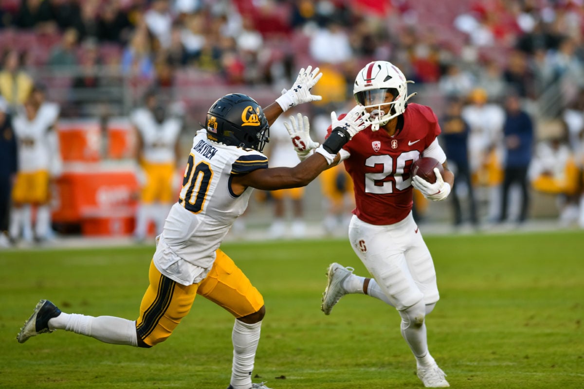 Junior running back Austin Jones rushing the ball downfield against a Cal defender.