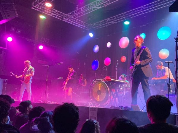 Performers from Japanese Breakfast on a purple stage.