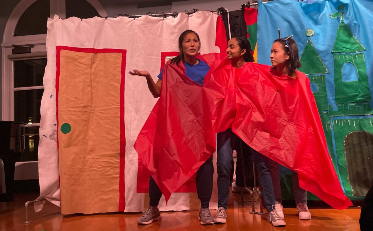 Photo of students Ginger Buck, Sahithi Pingali and Alexandra Huynh acting out a scene as a three-headed alien