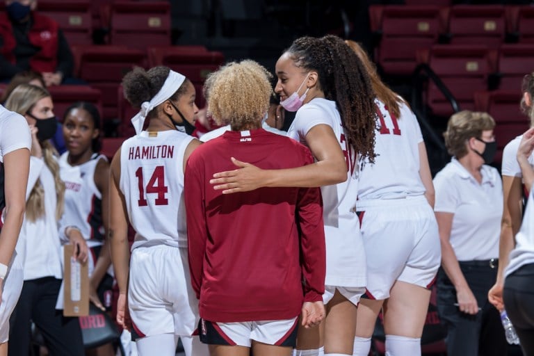 Stanford women's basketball huddles during a timeout.