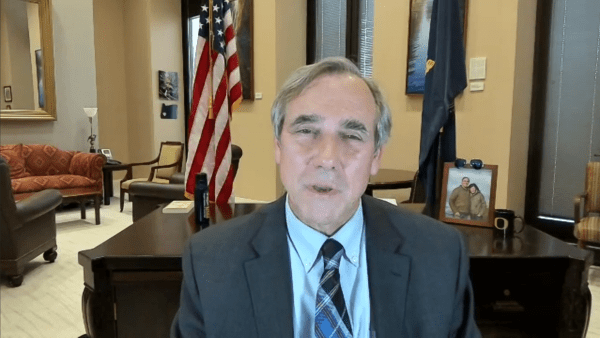 Senator Jeff Merkley speaking over zoom from in front of his desk.