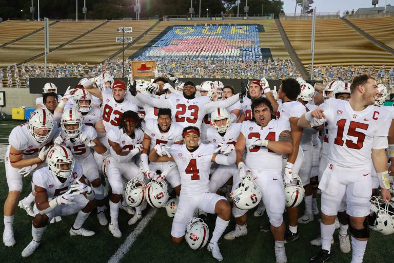 Stanford football players pose with the "Our Axe" design at Cal's stadium