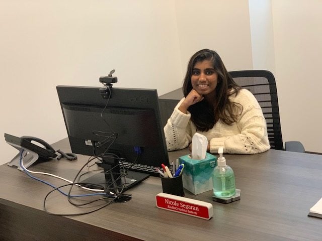 color pic of Nicole Segaran working behind desk as a RadioGraphics intern