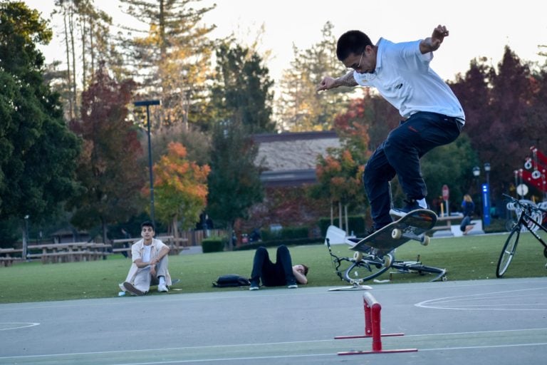 Christian Tocol jumps above a grind rail on the basketball courts on Wilbur Field.