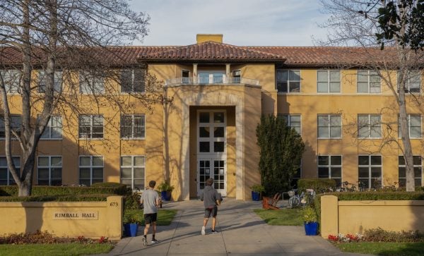 Two students walk towards the entrance of Kimball Hall