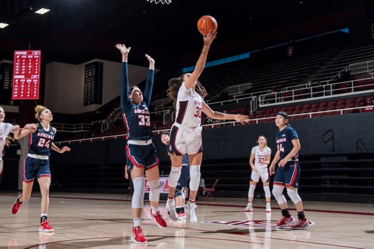 Junior guard Haley Jones jumps up for layup in front of an Gonzaga defender.