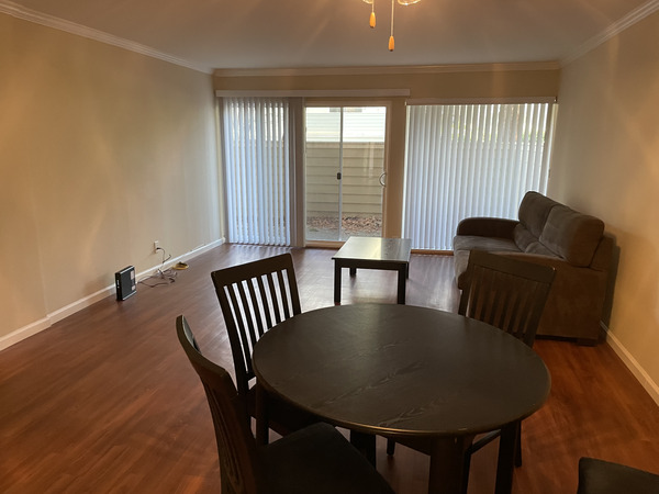 Living room of Sand Hill Place with couch, table and chairs.