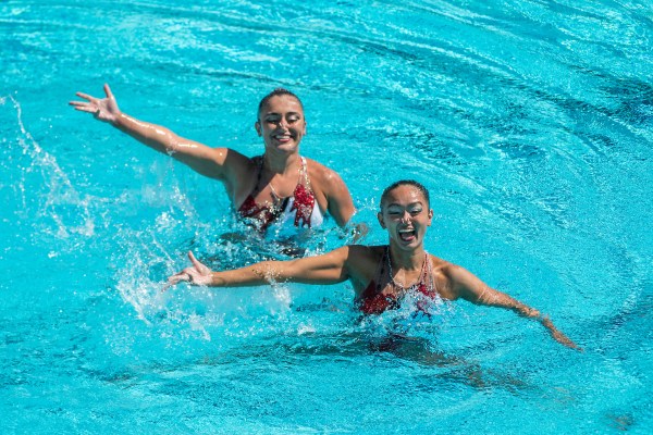 Jacklyn Luu and Emmanuella Tchakmakjian smile from the pool.