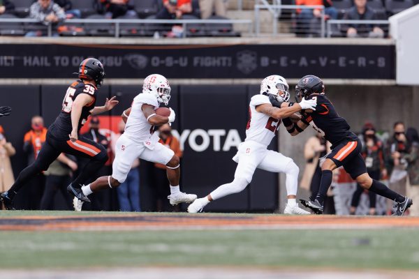 Nathaniel Peat runs with the ball while Austin Jones blocks for him..