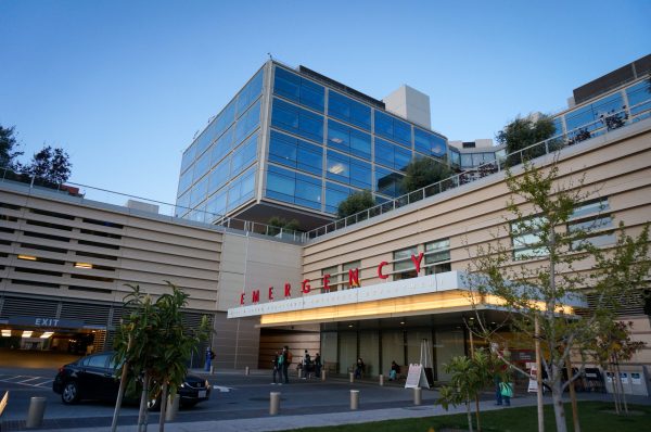 Entrance to Stanford Hospital's Emergency Department. Car passing by.