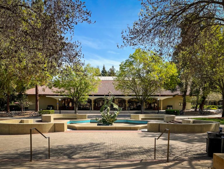 Empty plaza, showing Claw water fountain and Stanford Bookstore in the background.