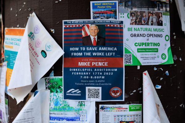 A poster promoting Pence's Thursday speech hangs on bulletin at Tressidder.