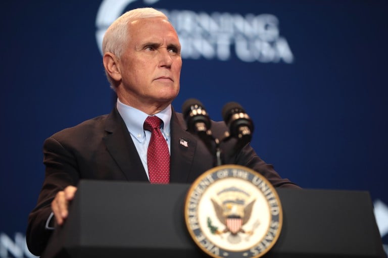 Mice pence on a podium with the presidential seal giving a speech