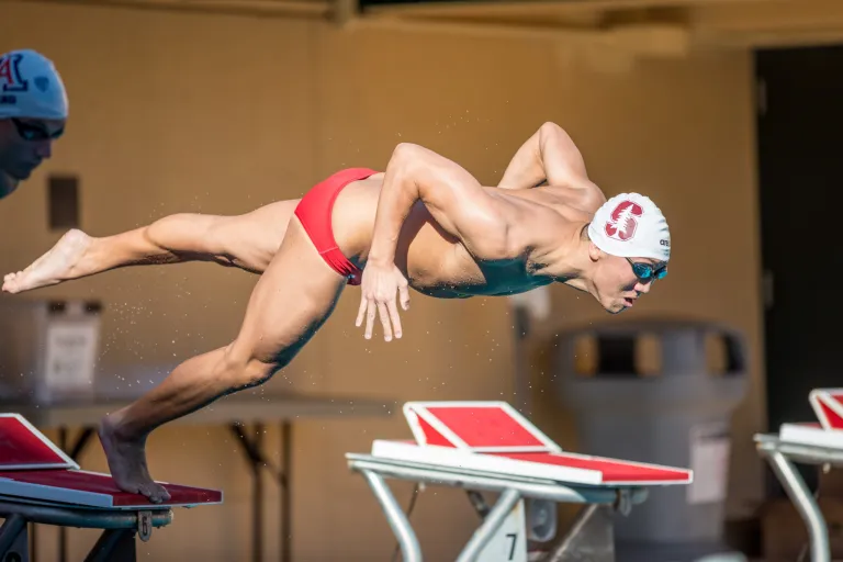 Graduate student Alex Liang dives into the pool.