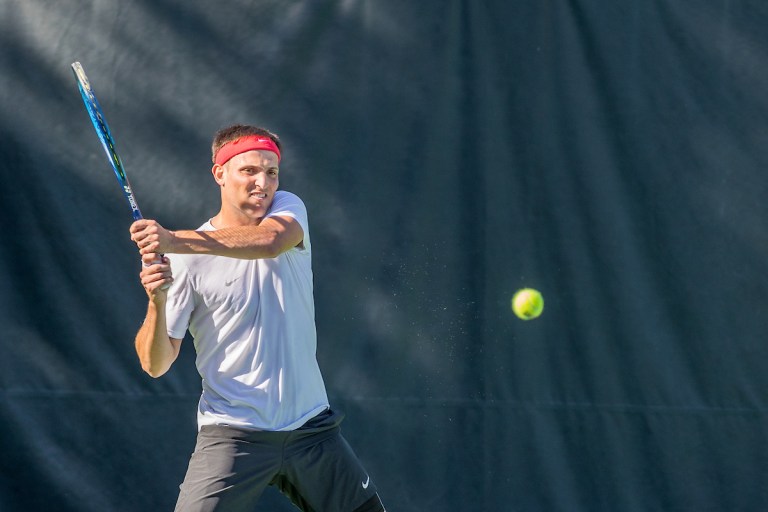 Axel Geller swings the racket at an oncoming ball.