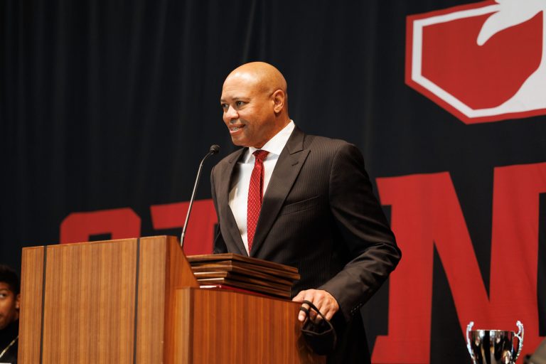 David Shaw speaks at the podium during an awards banquet.