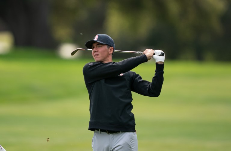 Sophomore Michael Thorbjornsen follows through after an iron shot.