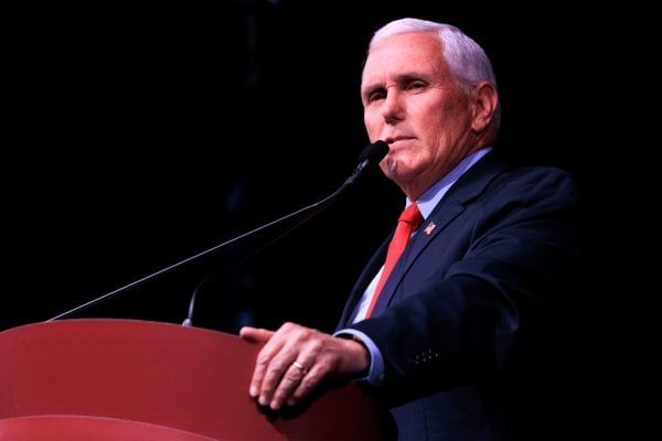 Former U.S. Vice President Mike Pence standing at a podium.