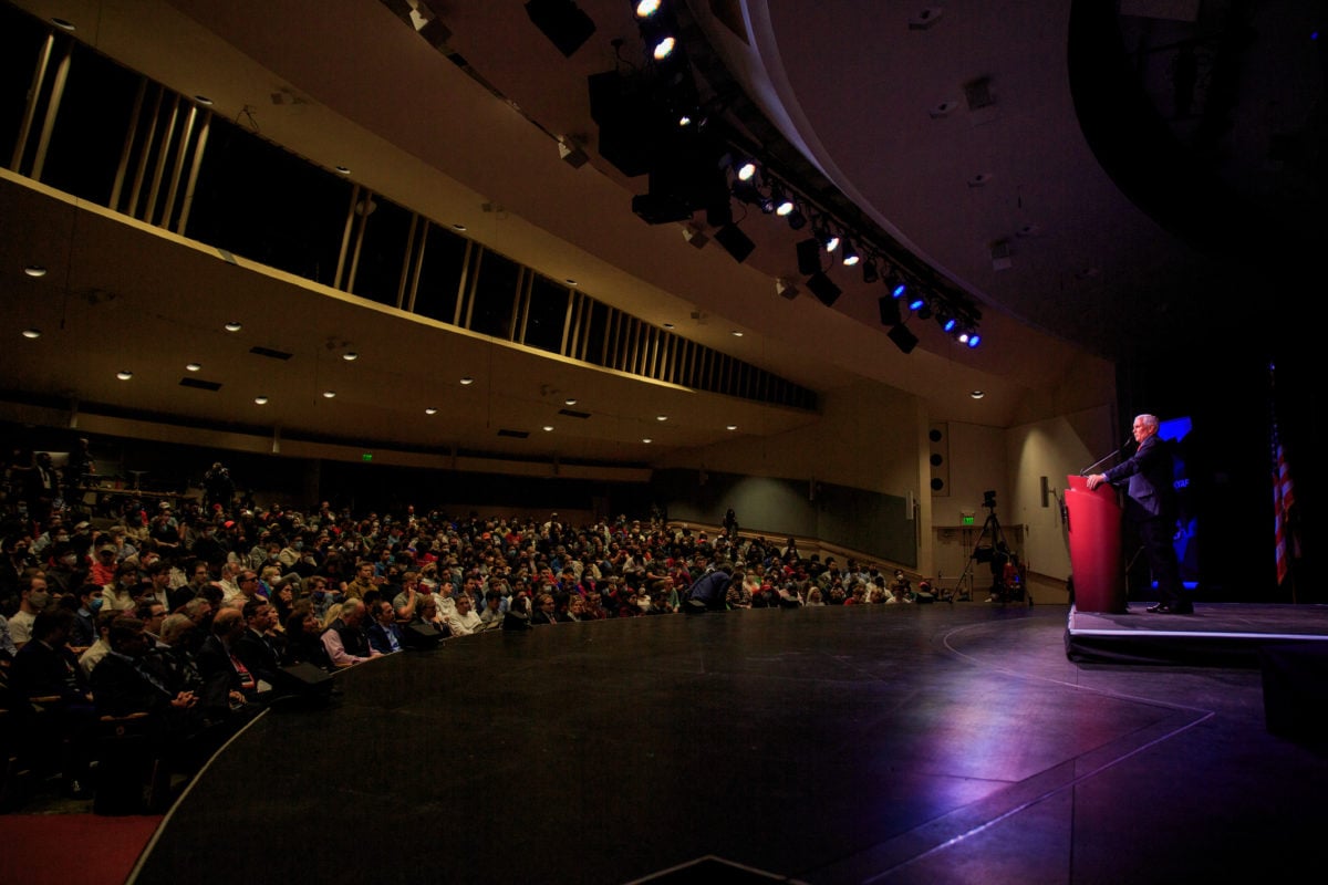 An image of Mike Pence speaking looking out to a packed audience.