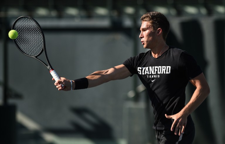 Tomas Kopczynski makes contact with the ball with his racquet on the court.