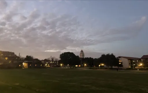 Sunset over Wilbur Field. Several dorm complexes and Hoover Tower can be seen in the distance.