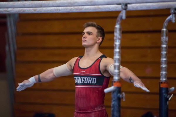 Senior Curran Phillips prepares for a routine on the bars.