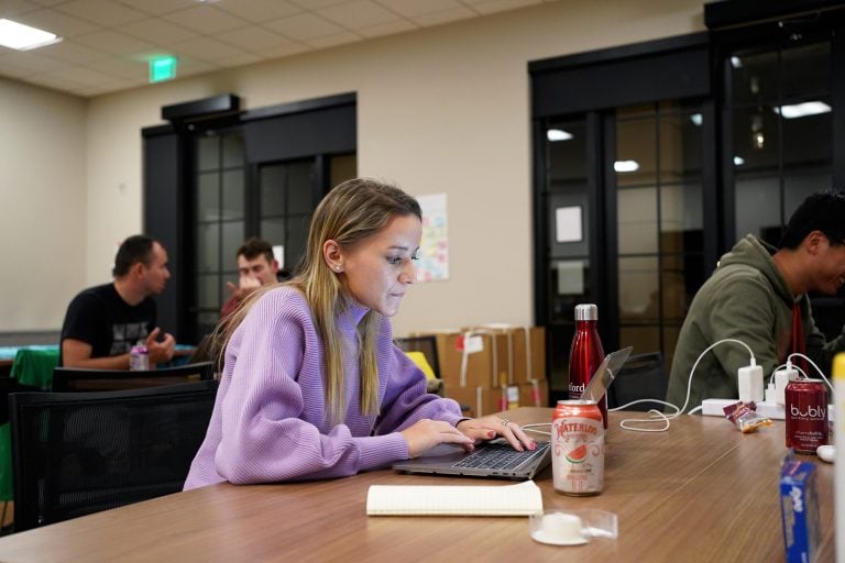 Kate Sliunkova works at a desk at the Coordination Hub.