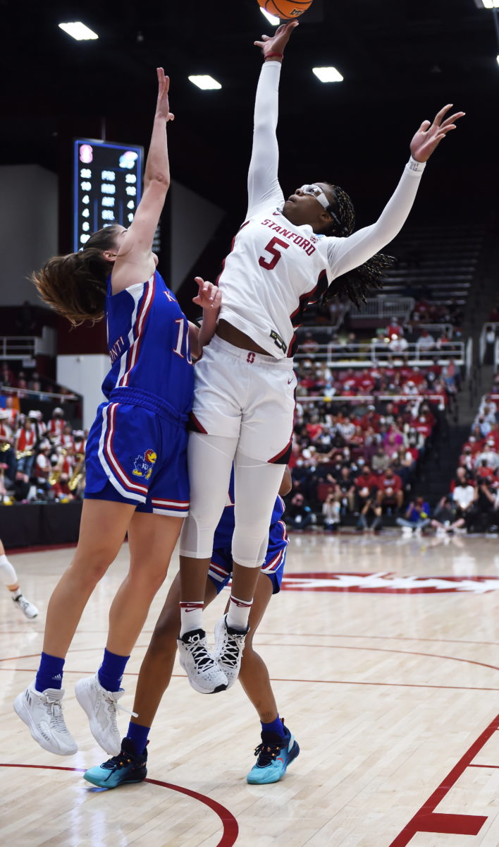 Belibi looks to shoot against two Kansas defenders.