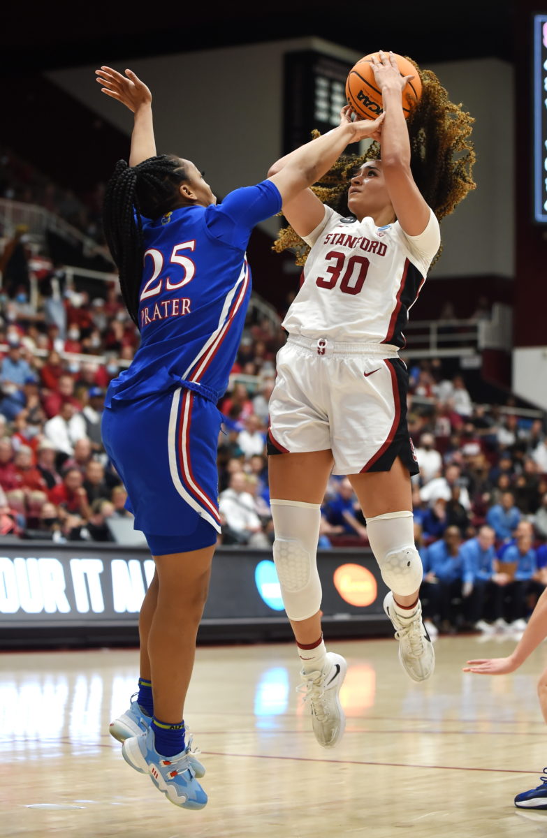 Junior guard Haley Jones shoots with a defender's hand in her face.