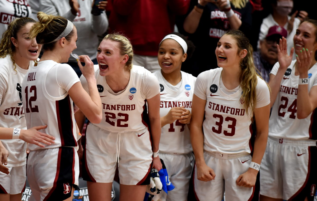 The team celebrates as Lexie Hull returns to the bench after 36 minutes on the floor.