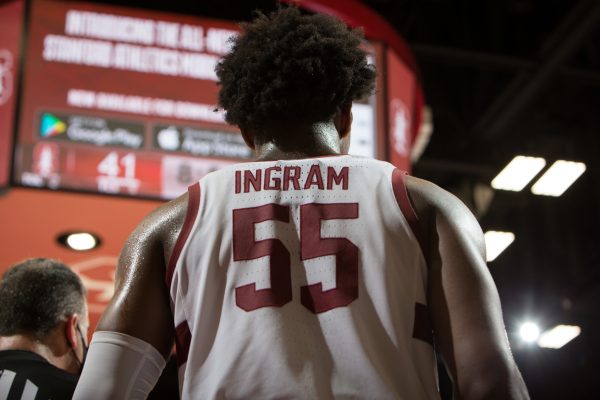 Freshman forward Harrison Ingram stands in front of the jumbotron.