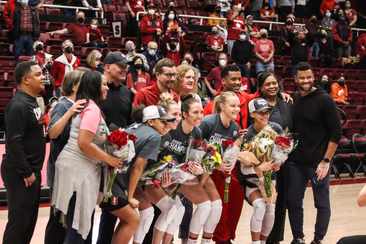 Five seniors, Jordan Hamilton, Lexie and Lacie Hull, Alyssa Jerome and Anna Wilson, pose post-game with their families.