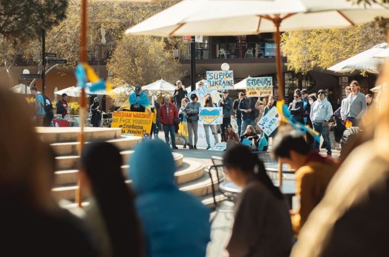 Students and community members on White Plaza with posters