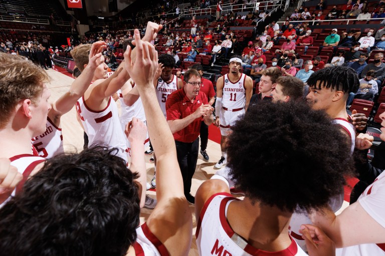 The Stanford men's basketball team gathers during a timeout.