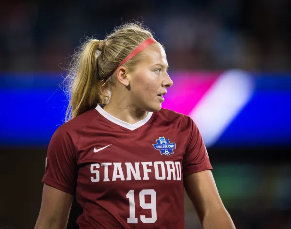 Katie Meyer in soccer gear looks to the side