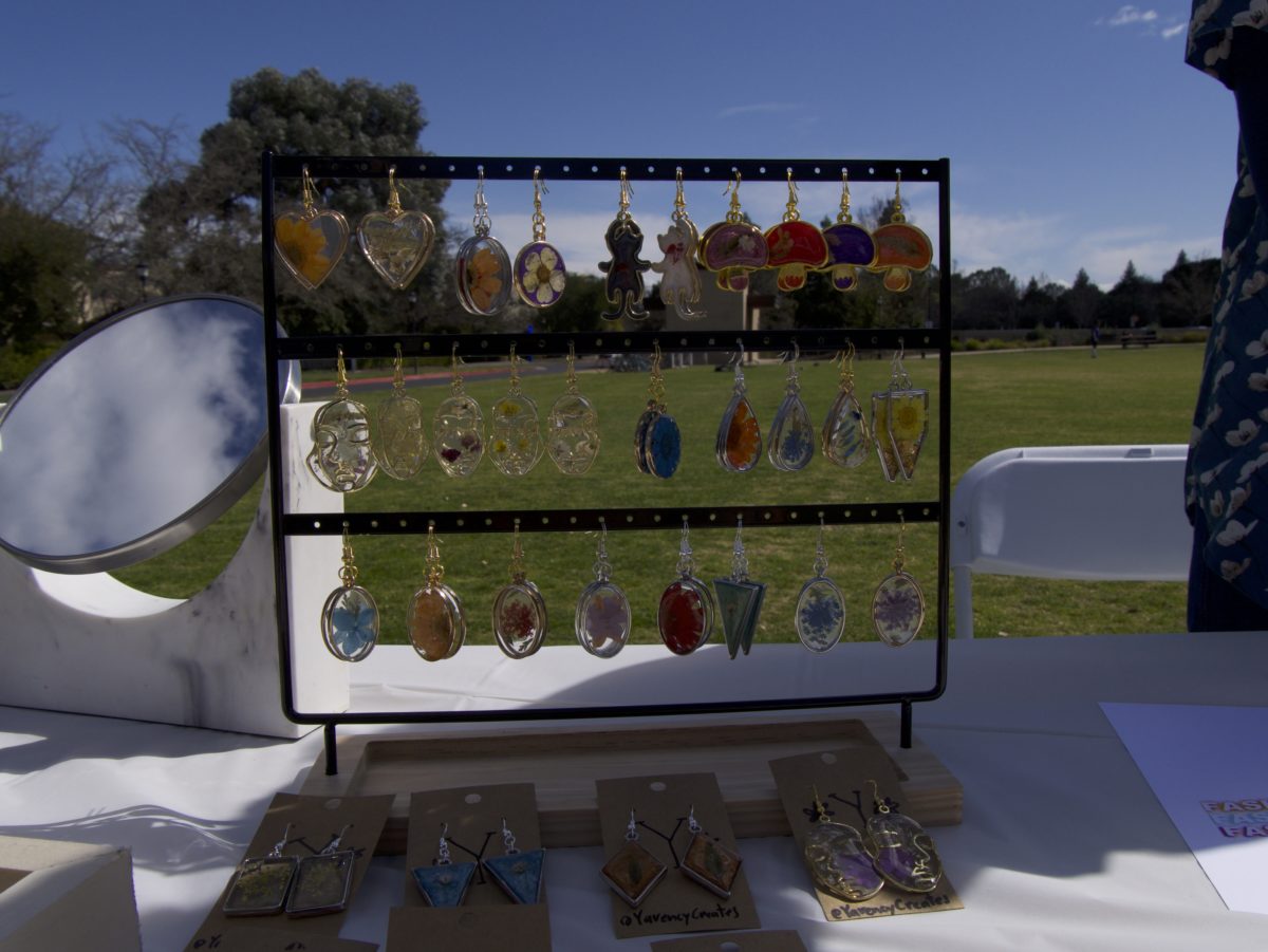 Earrings hang featuring bright colors.